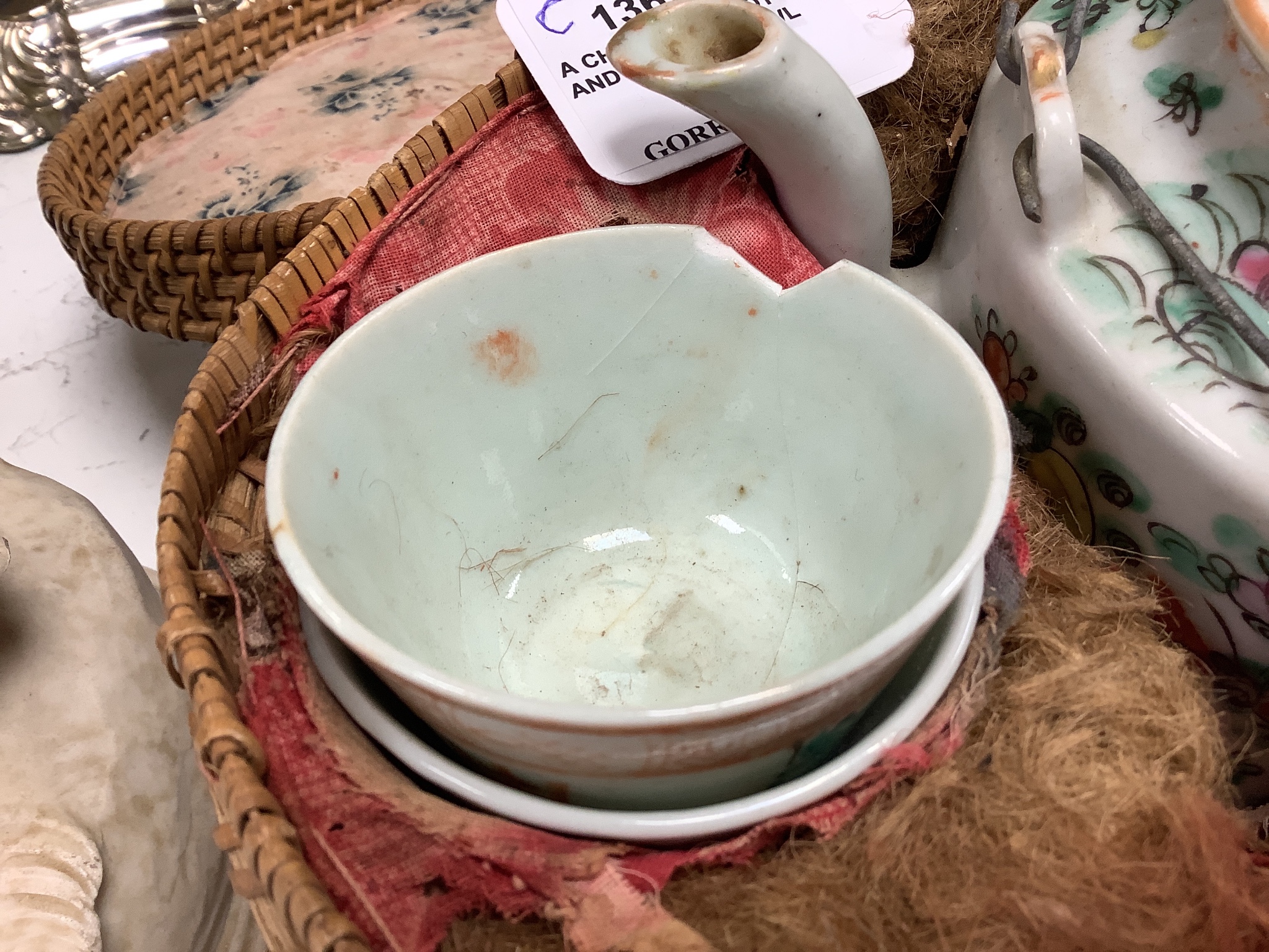 A Chinese teapot and two tea bowls, in carrying basket